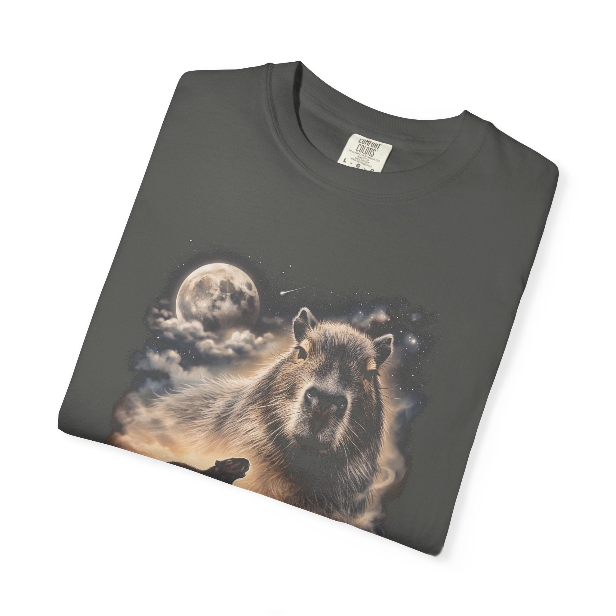Photorealistic double-exposure design of a capybara howling at a full moon over misty hills, in cream and gold on a dark tee.