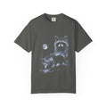Cold-toned airbrushed raccoon howling at the moon on black, in classic 90s nature-tee style.