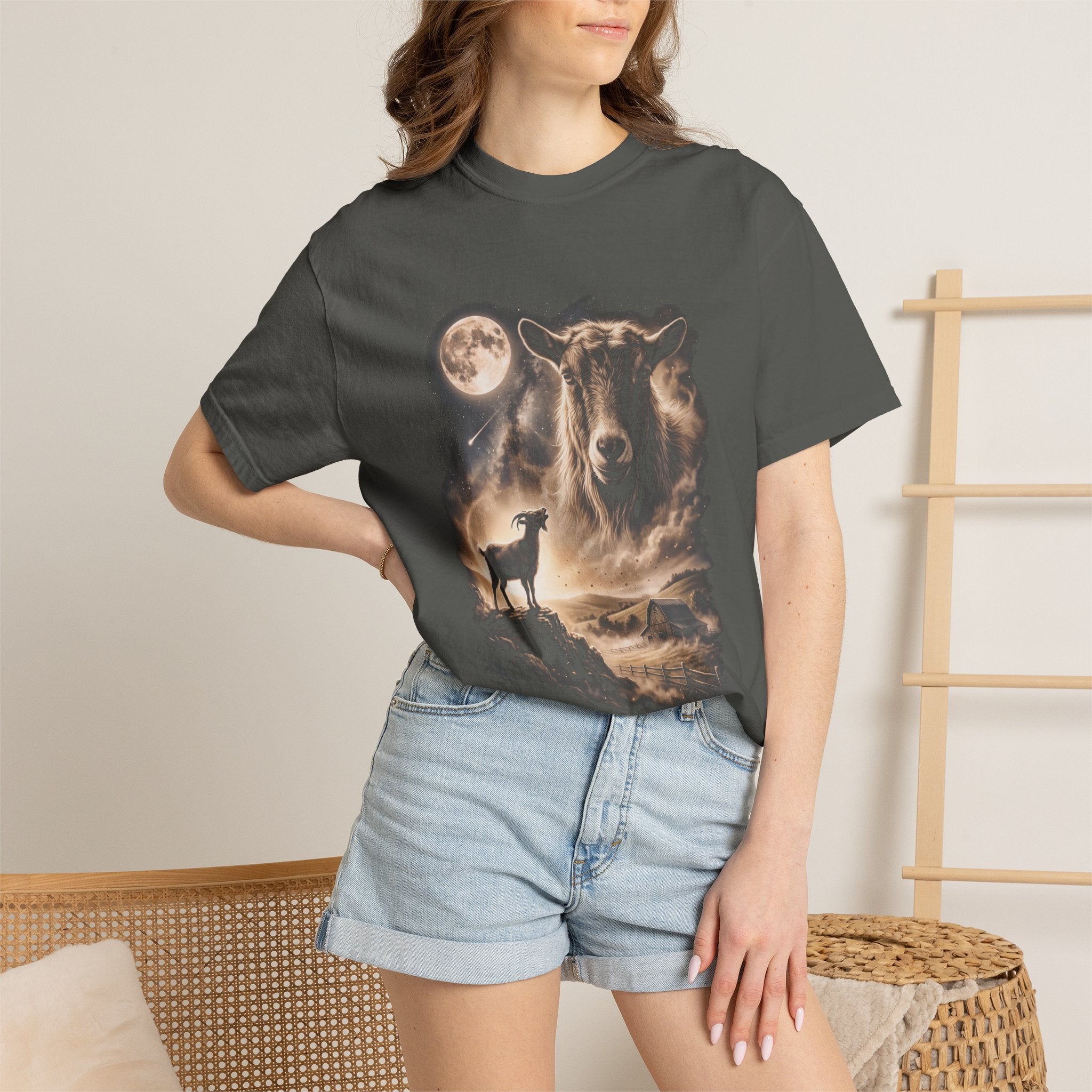 Dark t-shirt with airbrushed portrait of a goat above it howling at a full moon over misty fields