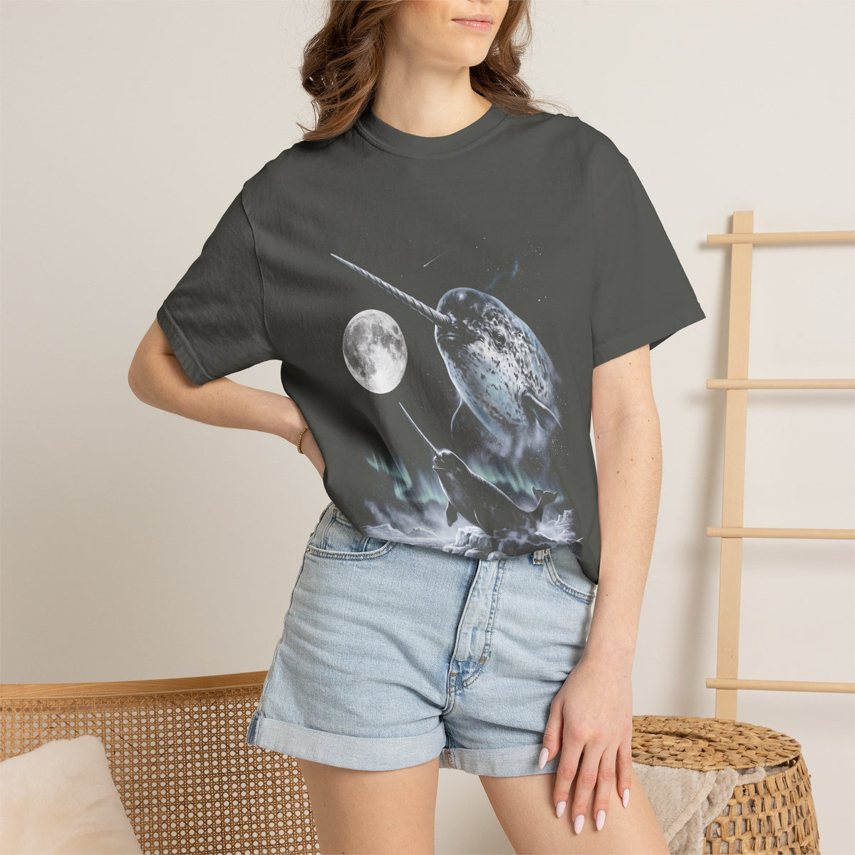 Airbrushed 1990s-style narwhal howling at the moon in cold monochrome blues and greys on black tee.