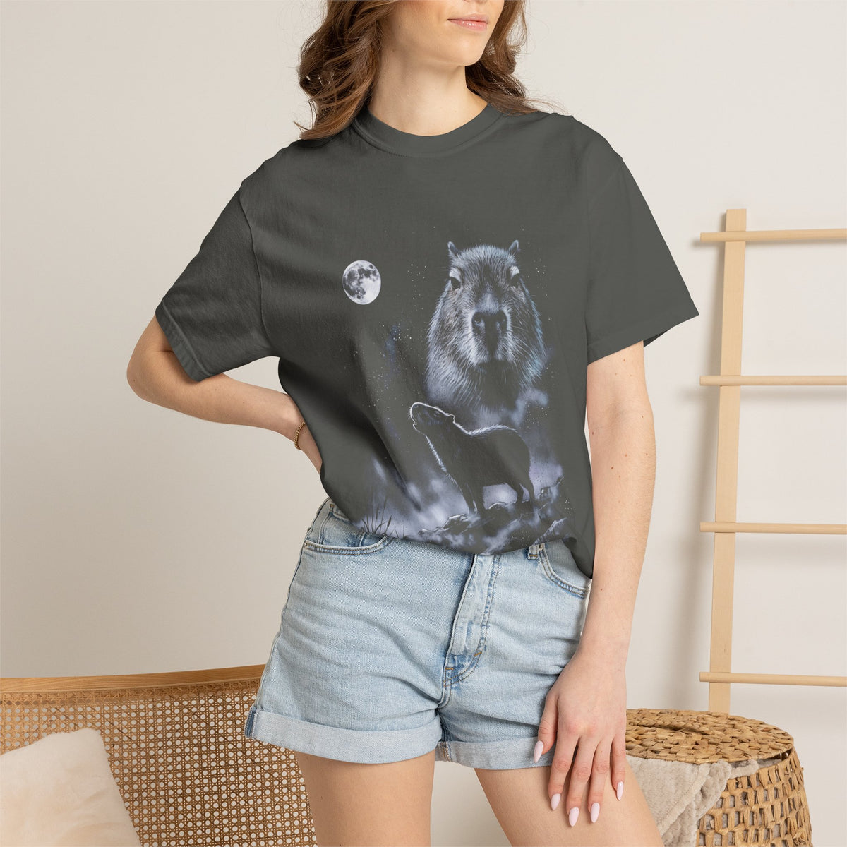 Airbrushed 90s-style art of a capybara howling at a full moon, cold blue-white tones on black.