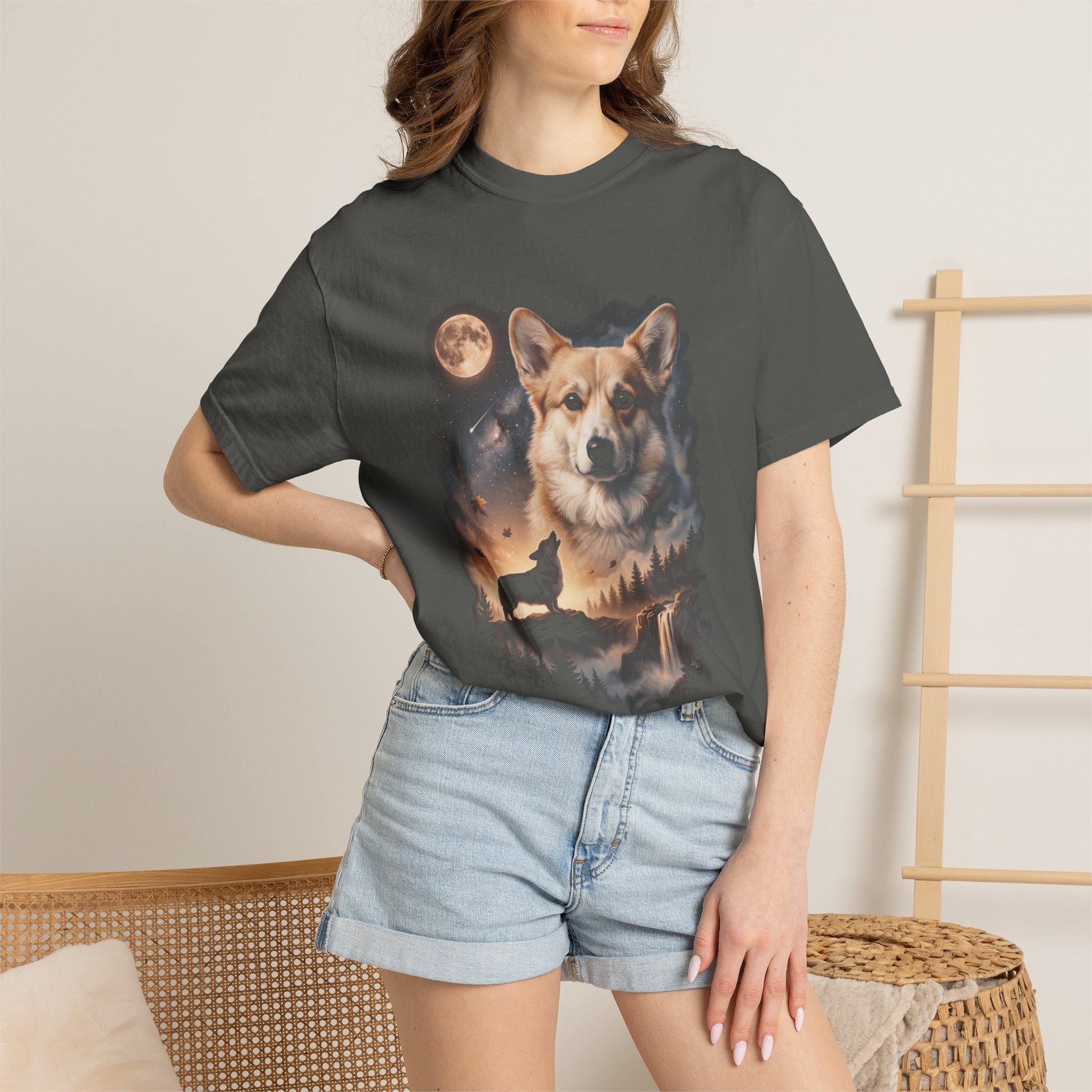Dark tee with cream and gold double-exposure art of a corgi howling at a full moon over misty hills
