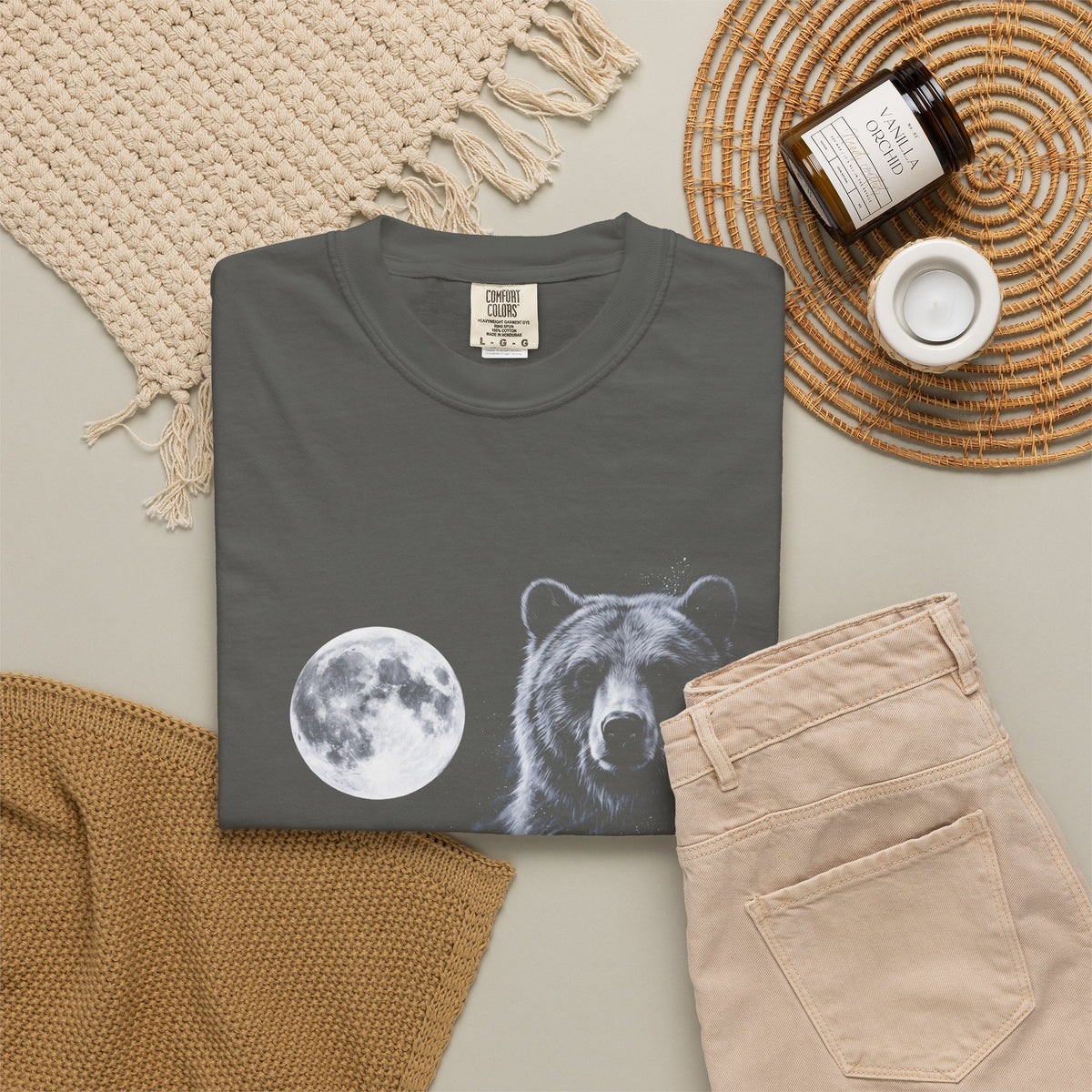 Airbrushed bear howling at a moon in white, silver and ice-blue tones against black, 1990s nature-tee style