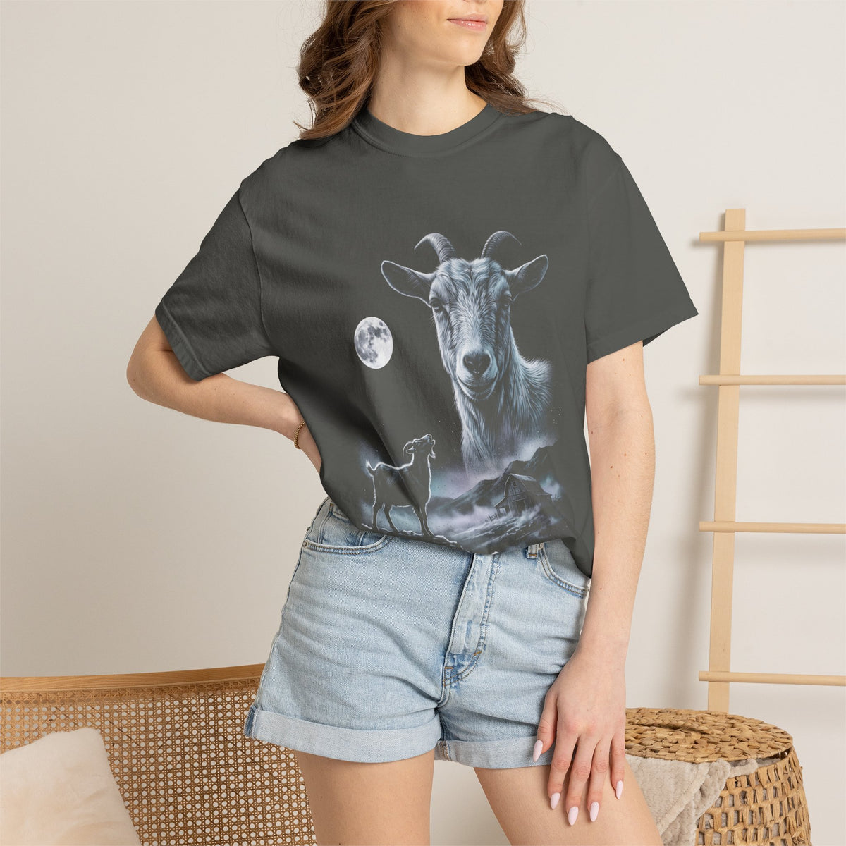Airbrushed illustration of a goat howling at a cold moonlit sky, in white, silver, and ice-blue tones on black.