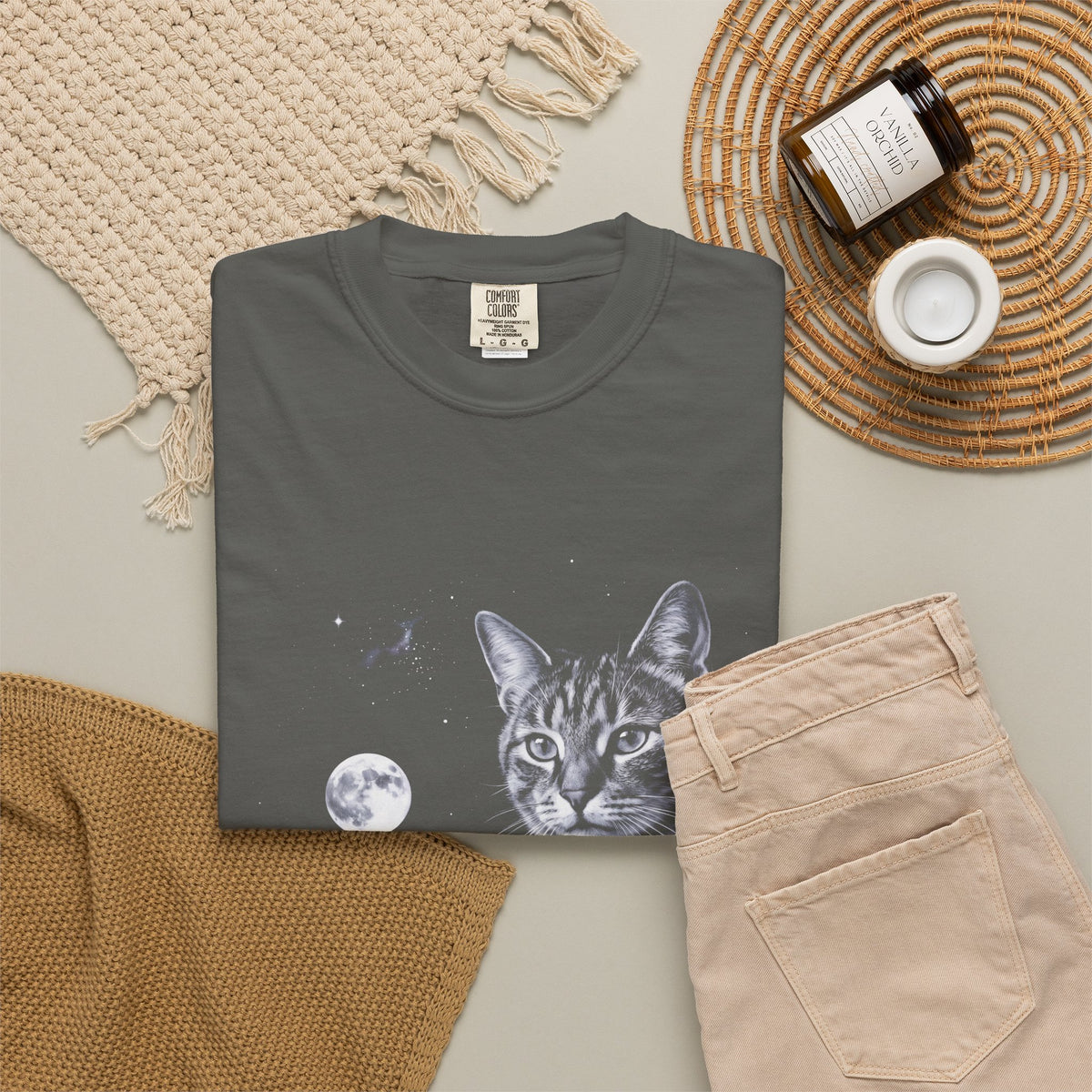Cold moonlit airbrush illustration of a house cat howling at the moon, in ash grey, silver, and ice blue on black.